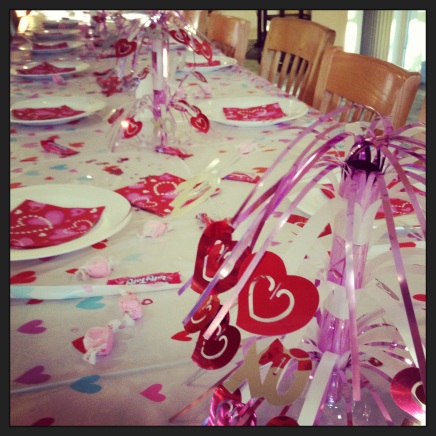 Table preparations for Valentine-themed dinner